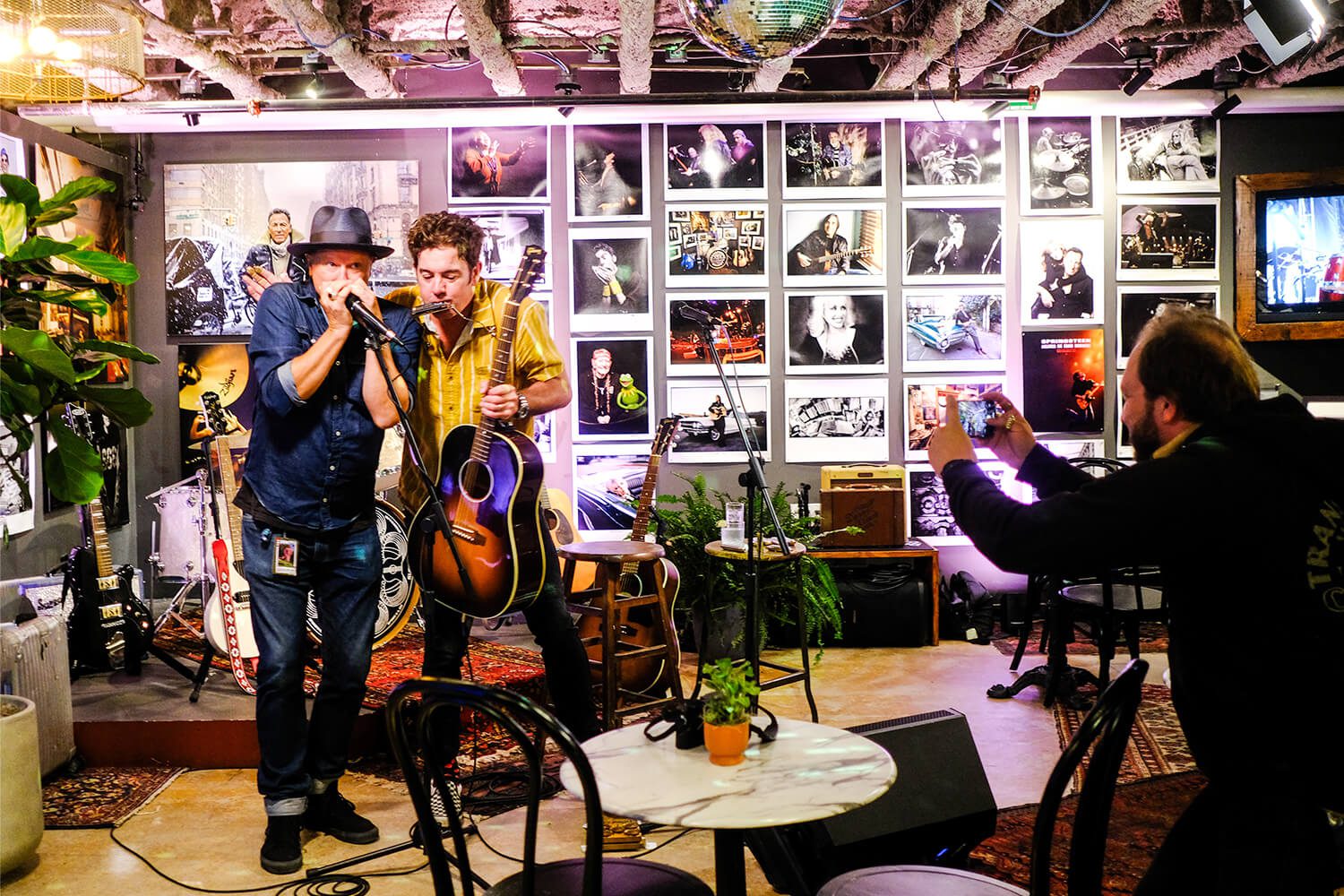 Musicians performing in a cozy, decorated venue.