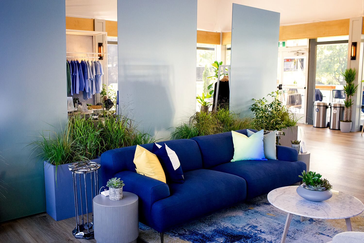 Modern living room with blue sofa.